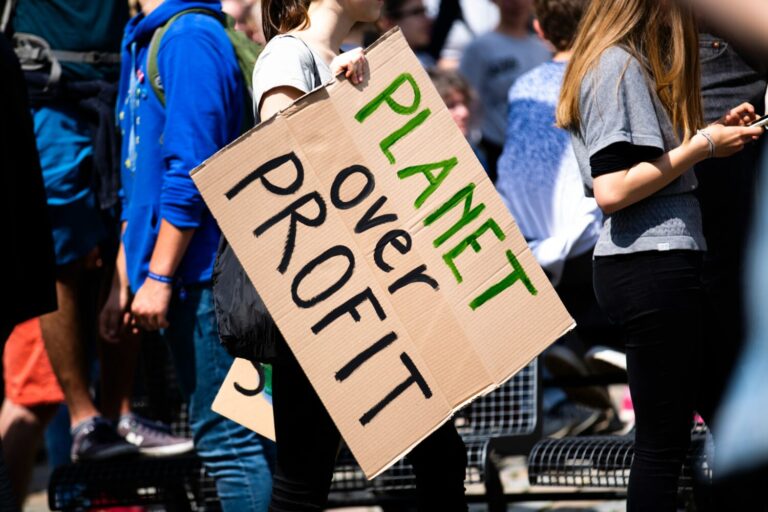 'Planet Over Profit' protest sign