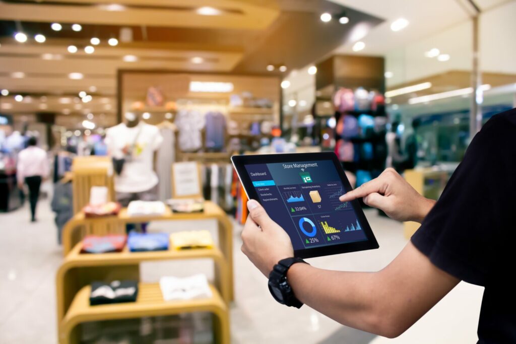 A shop worker using analytics on a smart device